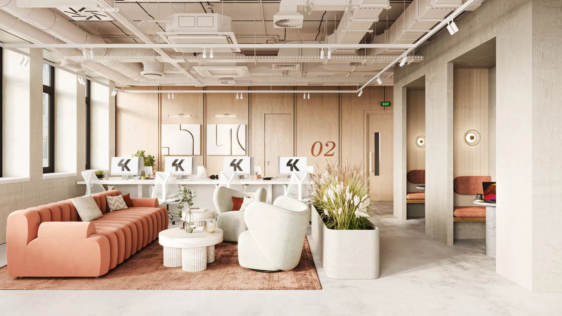 Workplace breakout area with a terracotta sofa and desks